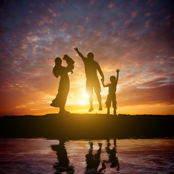 Family at sunset silhouettes Family at sunset silhouettes
